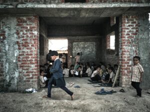 Children studying in a rustic educational setting in rural India.